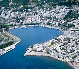 Kos Harbor and ShipyarA little further south (16 km. from Kos) is Pyli, 
						consisting of three villages in a 

lush, verdant setting. A sanctuary of Classical times has been
discovered here, finds from which are exhibited in the Kos Museum. Above the village are the remains of a 

Byzantine castle, within which the church of the Presentation of Christ is preserved and from where there is a 

superb view towards Kalymnos and Pserimos. 9 km. further south (25 km. from Kos) is Antimaeia, a cluster of 

four settlements built on a plateau. The airport is nearby and its port is Mastichari, the second largest of the 

island's harbors. Southeast of Antimacheia (29 km. from Kos) is Kardamaina which has developed to an attractive, 

well-planned holiday resort. Between here and Antimacheia are the ruins of a large Venetian castle with well-

preserved ails, a few houses, two churches and a cistern for water. The castle was probably built in 494 on the 

site of the preceding Byzantine fortress. At Kefalos (43 km. southwest of Kos) ere are ruins of ancient temples 

and a small theater. There is an Early Christian basilica at Aghios Stefanos and at Mastichari. Among the 
						lovely 

coastal villages are Tingaki (14 km. west Kos) and Aghios Fokas (8 km. east of Kos). Amenities and facilities 

on Kos are of a high standard, guaranteeing a pleasant vacation for II visitors. The beaches are excellent for 

						swimming, fishing and sea sports and those n the east coast, in close proximity to the 
						main town are particularly 

beautiful. On many others the trees grow down to the water's edge. Apart from the beach at Marmari, all the 
						others 

can be reached by bus. There is an organized spa at Thermes (11 km. southwest of 
						Kos) and other therapeutic 

springs near Karmaina. In the harbors of Kos, Mastichari, Kefalos and Kardamaina there are yacht marinas but 

there are refueling facilities only at Kos. Accommodation is available in hotels, 
						pensions, furnished flats and 

rooms.</font><div align=